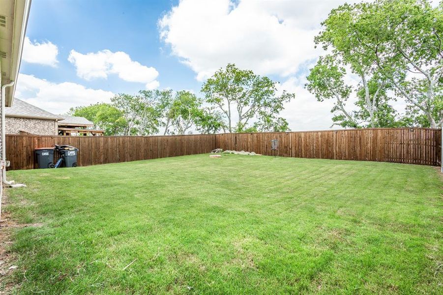 View of oversized 
fenced backyard