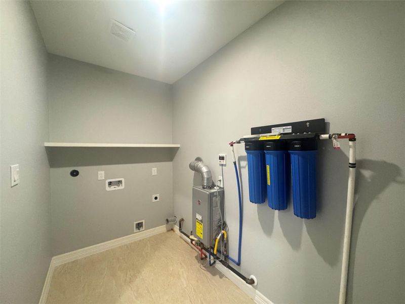 Utility room with gas dryer connection, whole house water purification system.