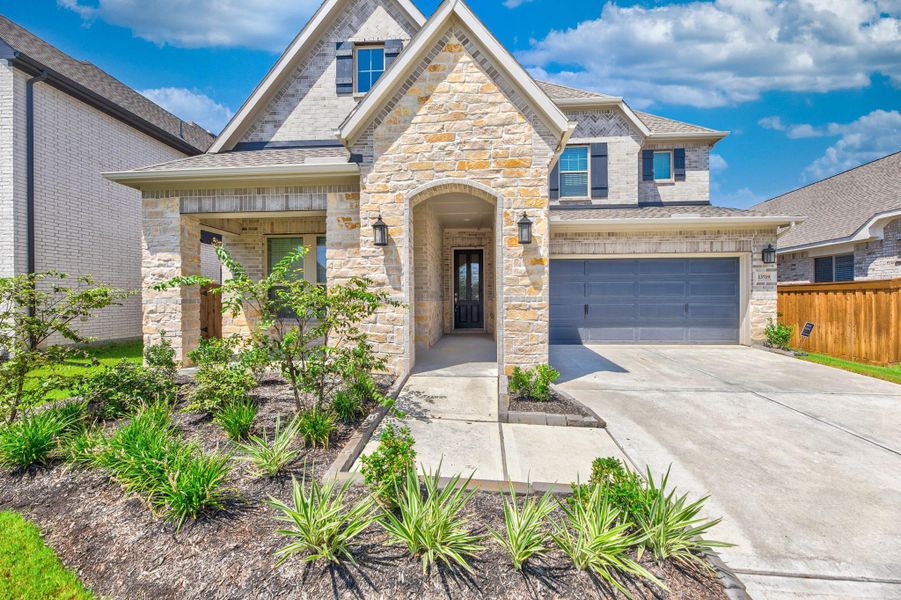 Front exterior of a new home in Dunham Pointe - Enclave Collection, Cypress, TX, highlighting curb appeal (Image 26).