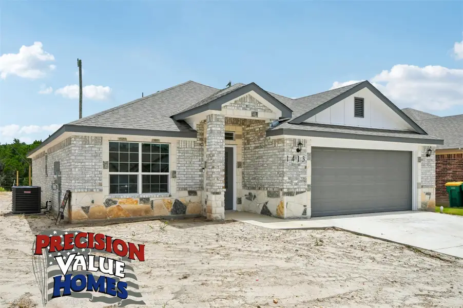 A newly constructed residence features a striking combination of light brick and natural stone accents. A newly constructed residence features a striking combination of light brick and natural stone accents.