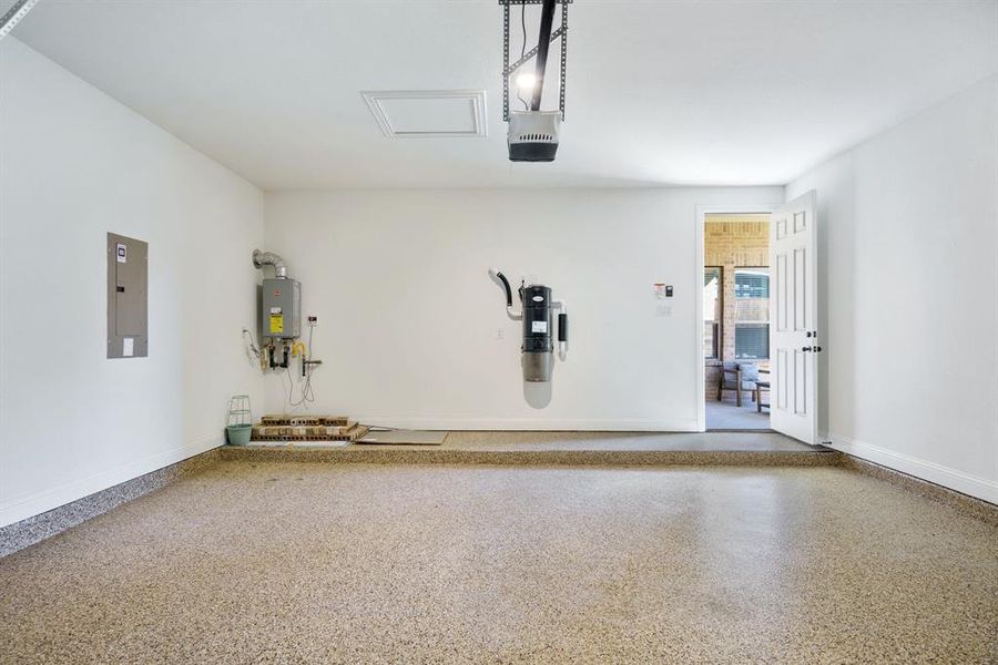 This shot of the garage highlights the upgraded epoxy flooring, built-in central vacuum system, and tankless water heater — making everyday life a little easier (and cleaner!).