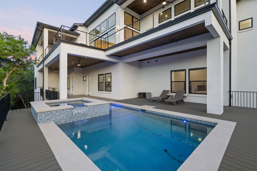 Outdoors, multiple covered terraces invite year-round enjoyment with a resort-style pool and spa, summer kitchen, firepit, and sweeping canyon views.