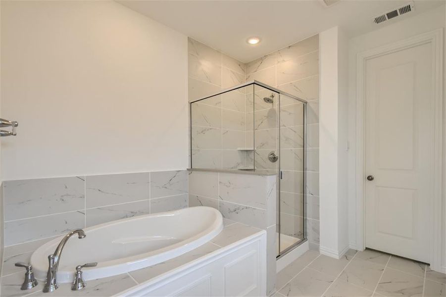 Bathroom featuring tile flooring and plus walk in shower