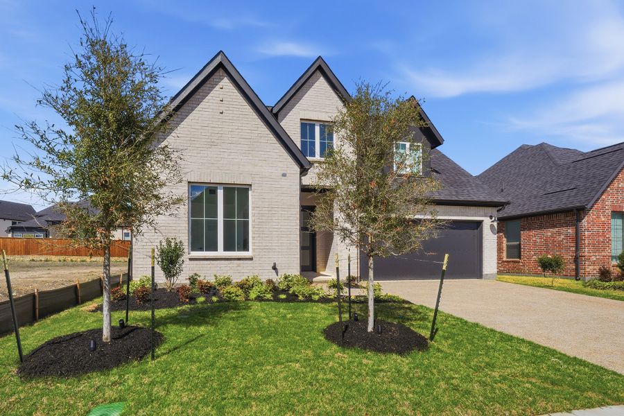 Front exterior of a new home in Brookhollow West, Prosper, TX, highlighting curb appeal (Image 23). Front exterior of a new home in Brookhollow West, Prosper, TX, highlighting curb appeal (Image 23).