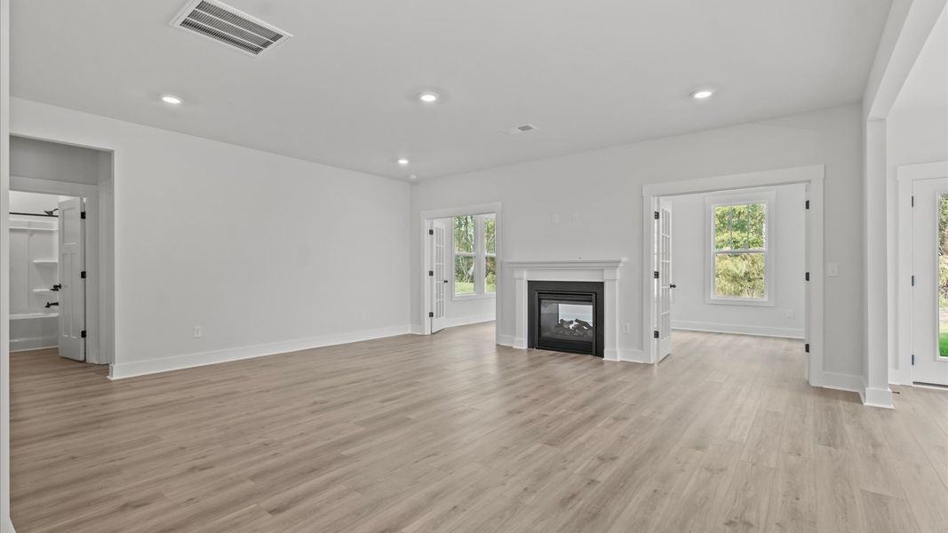 Exceptional family space with fireplace, hardwood floors, and seamless flow to dining and kitchen areas