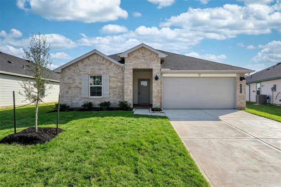 Front exterior of a new home in Tamarron, Fulshear, TX, highlighting curb appeal (Image 1). Front exterior of a new home in Tamarron, Fulshear, TX, highlighting curb appeal (Image 1).