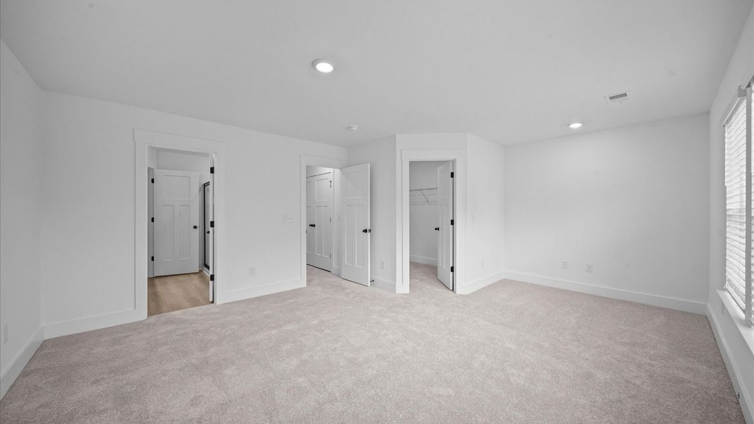 Exclusive upstairs retreat with a bright and airy primary suite with a walk-in closet