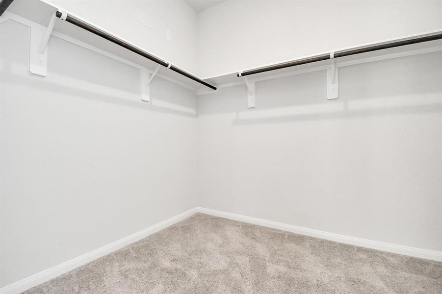 Walk-in closet that epitomizes luxury and practicality. This generously sizedspace features built-in shelving, offering abundant room for impeccableorganization. High ceilings and recessed lighting create a bright andwelcoming ambiance.