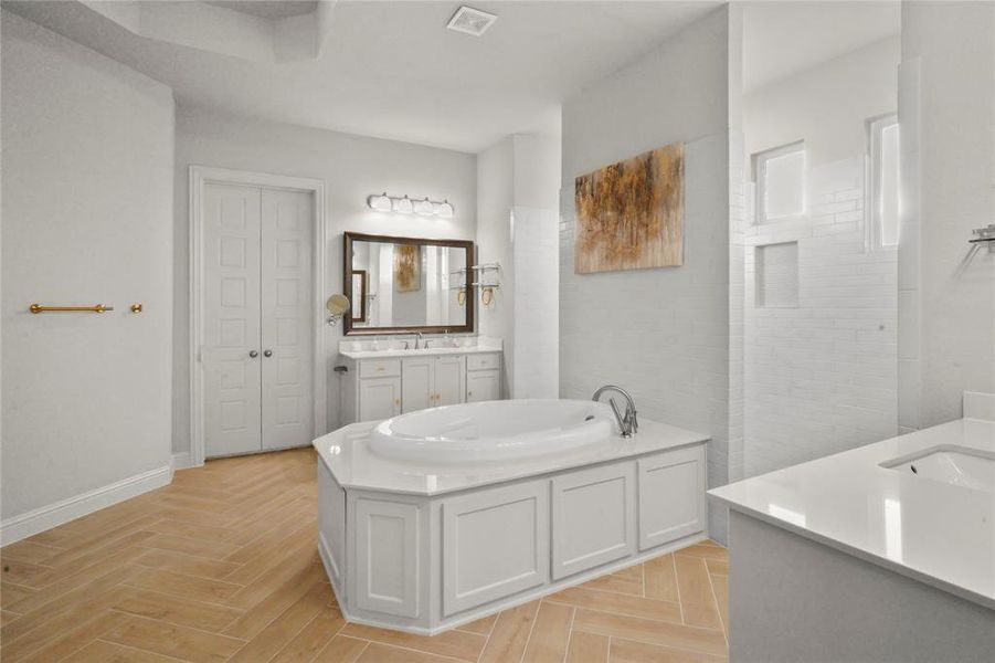 Full bath featuring a garden tub and two vanities Full bath featuring a garden tub and two vanities