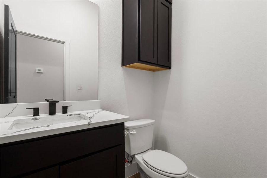 Half bath with vanity and toilet