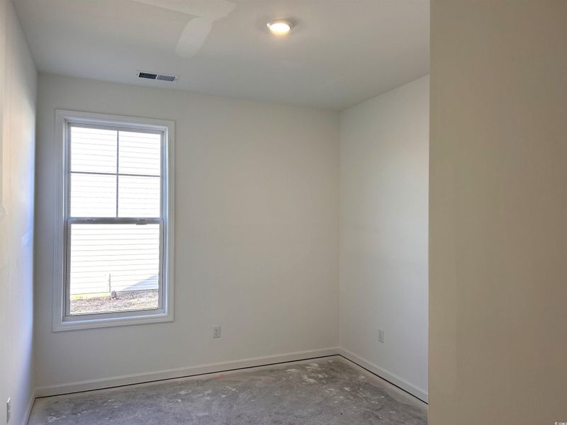 Unfurnished room featuring concrete floors