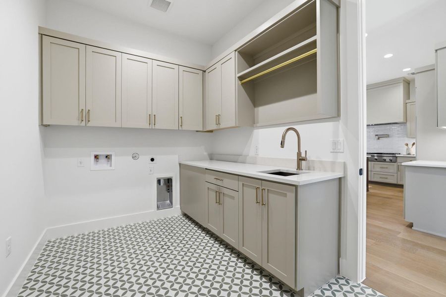 Laundry area with gas dryer hookup, recessed lighting, hookup for a washing machine, and cabinet space