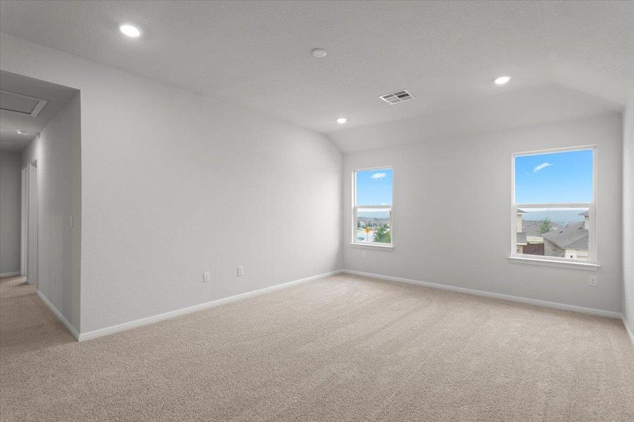 Spacious room featuring neutral carpeting and white walls