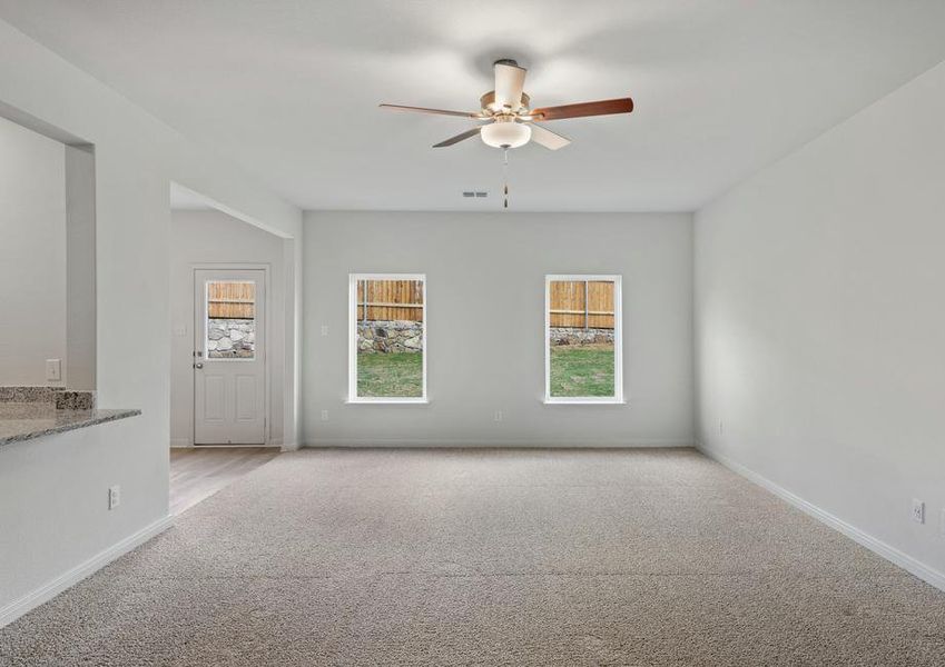 The spacious family room has large windows that let in great natural light and backyard views.