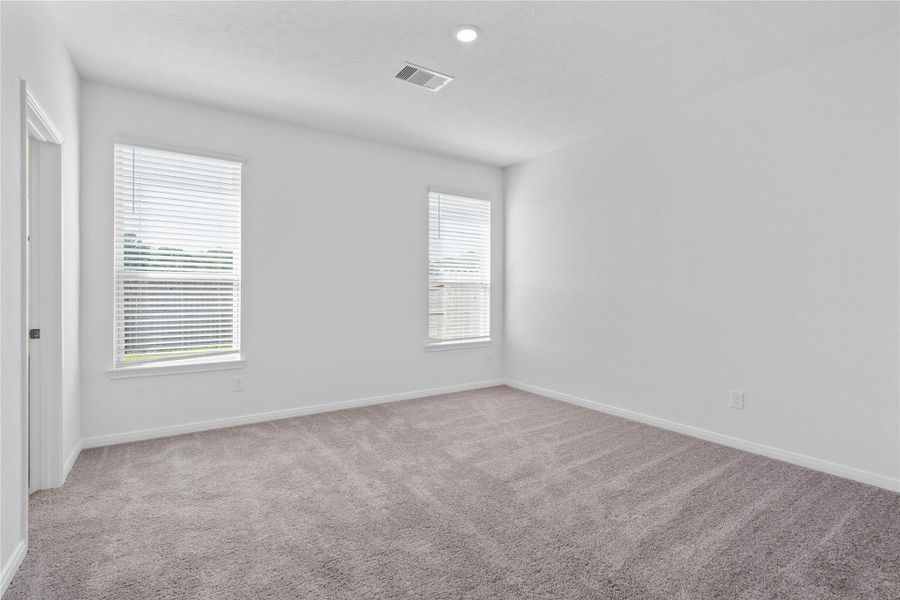 Unwind in your private sanctuary. This tranquil primary suite is a true retreat, offering a sense of calm and luxury. With plush carpeting, walk-in closet, and en-suite bath, it's the perfect place to start and end your day. Unwind in your private sanctuary. This tranquil primary suite is a true retreat, offering a sense of calm and luxury. With plush carpeting, walk-in closet, and en-suite bath, it's the perfect place to start and end your day.