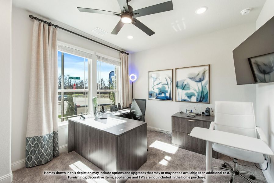 Home office with wood desk, ceiling fan, carpet flooring, and large window with natural light