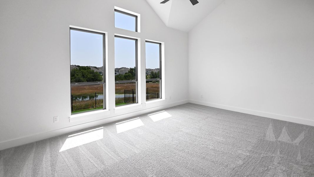 Kitchen with appliances with stainless steel finishes, a sink, light countertops, wood finished floors, and white cabinetry