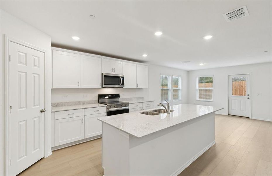 Spacious kitchen with eat-in bartop island