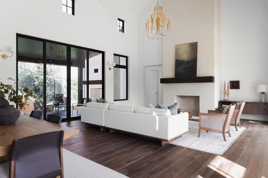 The main living area features a soaring great room that anchors the entire floorplan, designed for a natural flow between the kitchen and the outdoor entertaining spaces. The high ceilings and open layout make this the primary spot for daily life and gathering.