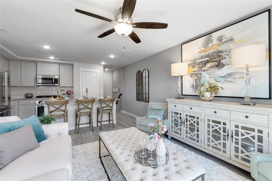 Living room featuring light hardwood / wood-style flooring and ceiling fan