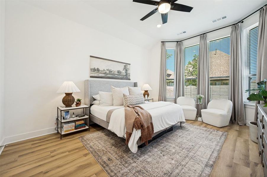 Large bright master bedroom with large bay windows
