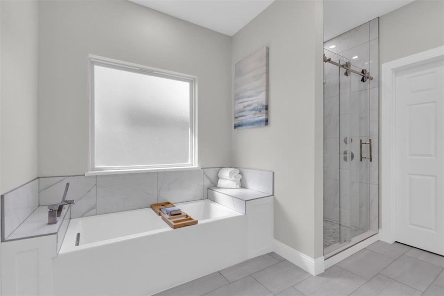 Full bathroom with a shower stall, a garden tub, and light tile patterned floors