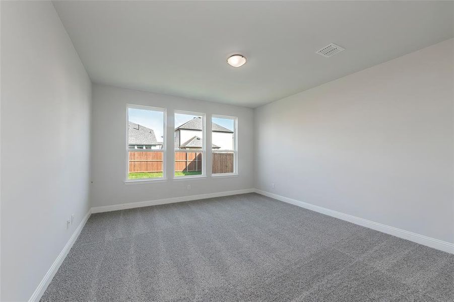 Carpeted spare room with baseboards Carpeted spare room with baseboards