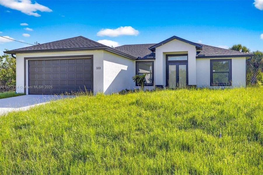 Front exterior of a new home in , Lehigh Acres, FL, highlighting curb appeal (Image 2). Front exterior of a new home in , Lehigh Acres, FL, highlighting curb appeal (Image 2).