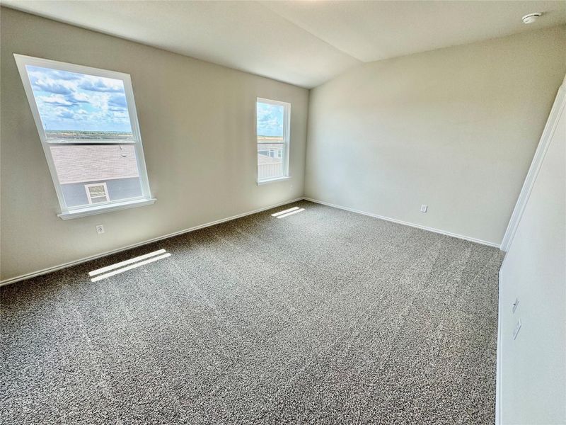 Spare room with carpet floors and vaulted ceiling Spare room with carpet floors and vaulted ceiling