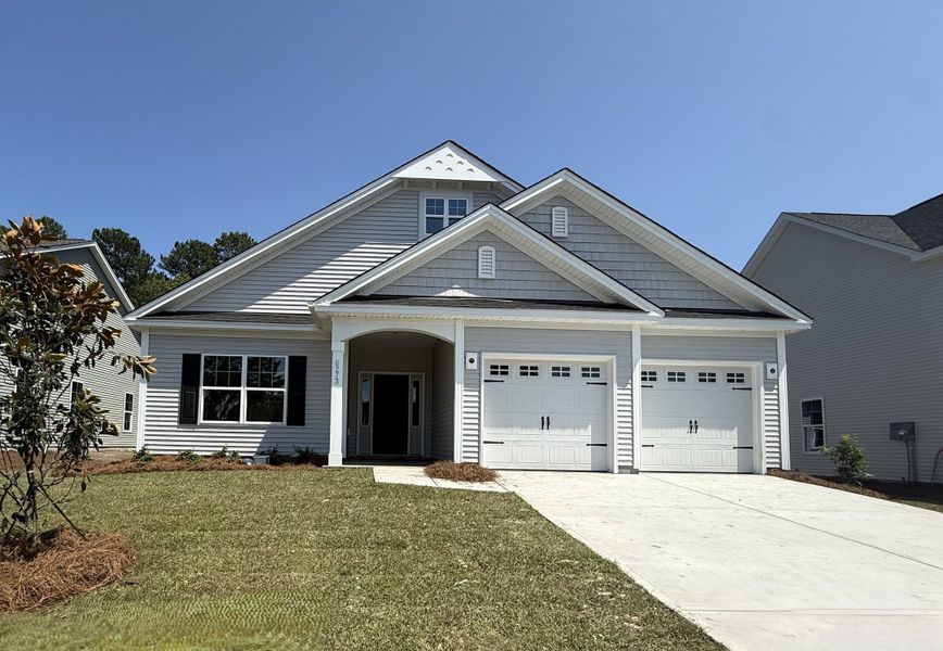 Front exterior of a new home in Arcadia, Myrtle Beach, SC, highlighting curb appeal (Image 1). Front exterior of a new home in Arcadia, Myrtle Beach, SC, highlighting curb appeal (Image 1).