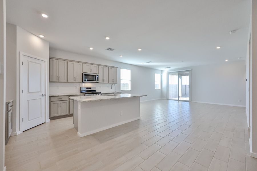 A large kitchen with white cabinets. A large kitchen with white cabinets.