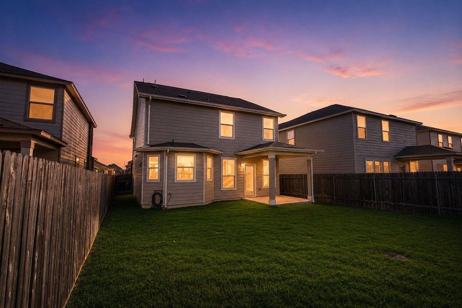 A private yard with a covered patio offers twilight relaxation. A private yard with a covered patio offers twilight relaxation.