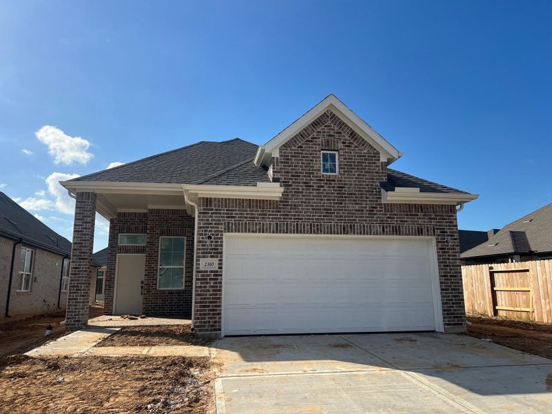 Front exterior of a new home in Wood Leaf Reserve, Tomball, TX, highlighting curb appeal (Image 1). Front exterior of a new home in Wood Leaf Reserve, Tomball, TX, highlighting curb appeal (Image 1).