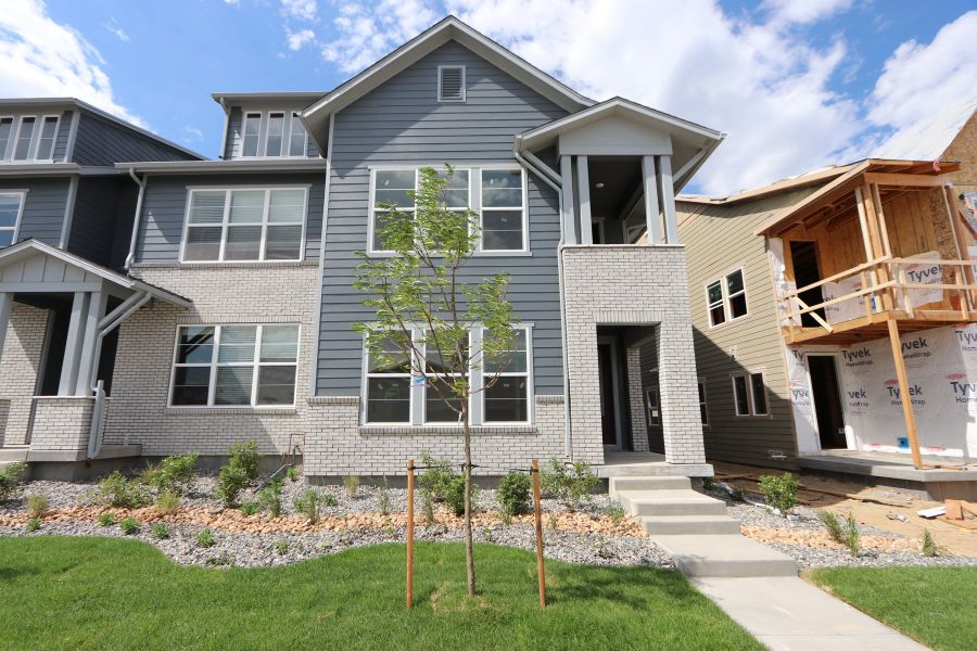 Front exterior of a new home in Kinston Mainstreet Townhomes, Loveland, CO, highlighting curb appeal (Image 2). Front exterior of a new home in Kinston Mainstreet Townhomes, Loveland, CO, highlighting curb appeal (Image 2).