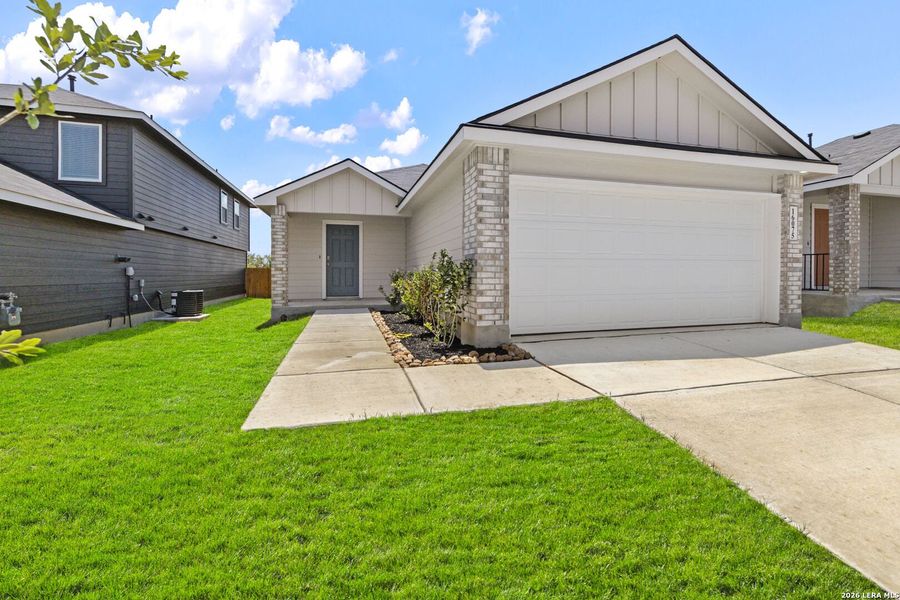 Front exterior of a new home in Hickory Ridge, Elmendorf, TX, highlighting curb appeal (Image 2).
