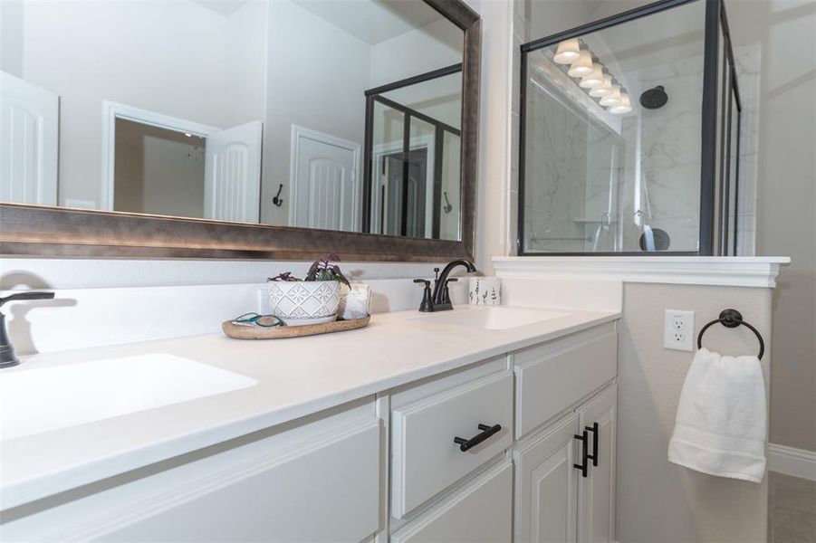 Double vanity with custom mirror and cabinet hardware