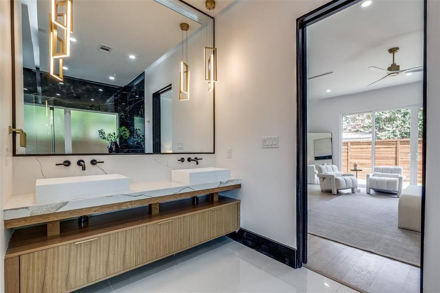 Bathroom featuring dual vanity, hardwood / wood-style flooring, and ceiling fan