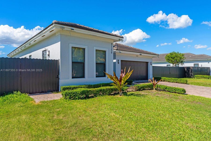 Front exterior of a home in the Century Royal Homes community, located in Homestead, FL (Image 12).