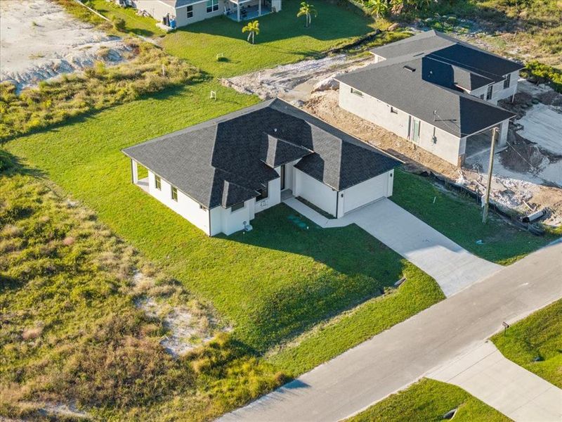Front exterior of a new home in , Lehigh Acres, FL, highlighting curb appeal (Image 17).