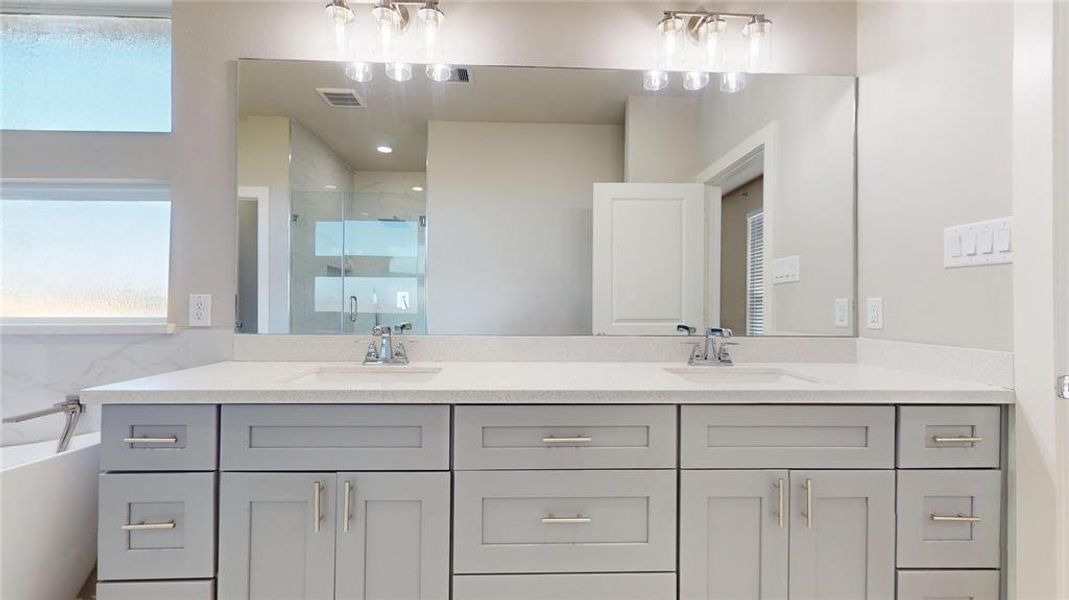 The large double vanity in the primary bath has ample storage.