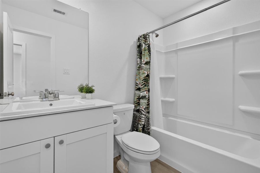 Secondary full bath located upstairs.