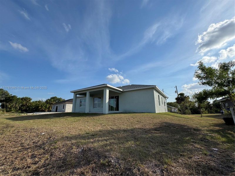 Front exterior of a new home in , Labelle, FL, highlighting curb appeal (Image 1).