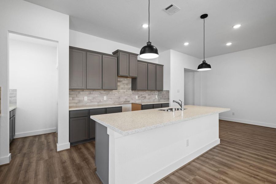 Every detail has been thoughtfully designed, from the additional prep area and walk-in pantry, to the charming backsplash that adds a touch of personality.