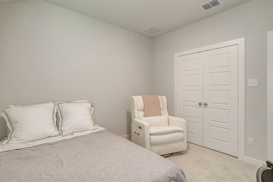 Bedroom with light carpet and a closet Bedroom with light carpet and a closet