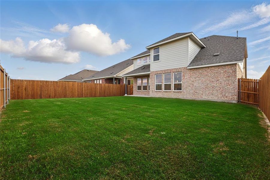 Rear view of property with brick siding and a shingled roof Rear view of property with brick siding and a shingled roof
