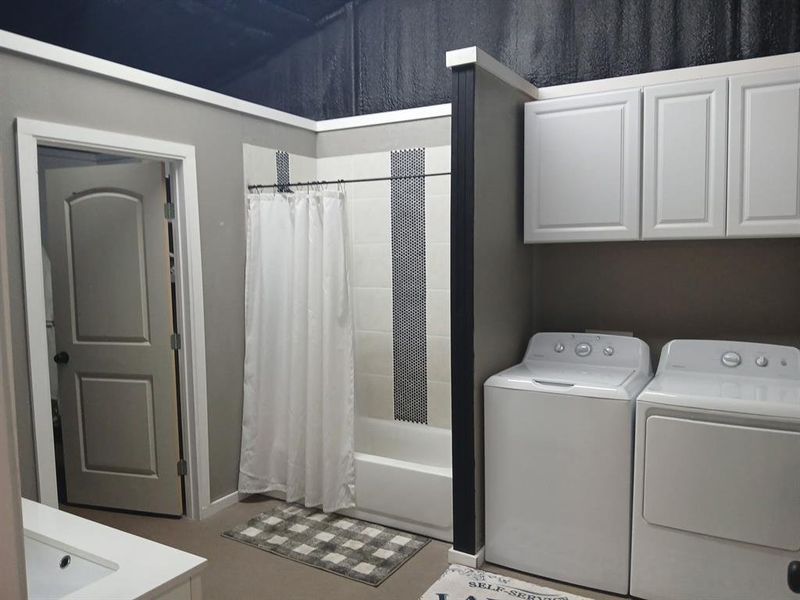 Laundry room with washing machine and clothes dryer