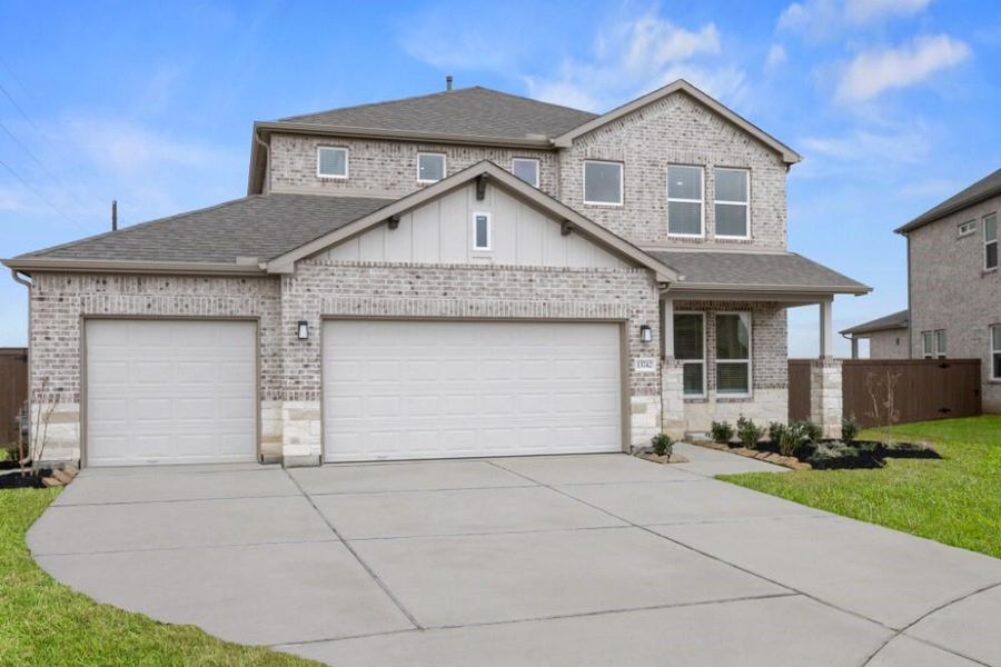 Front exterior of a new home in Creekhaven, Iowa Colony, TX, highlighting curb appeal (Image 16).