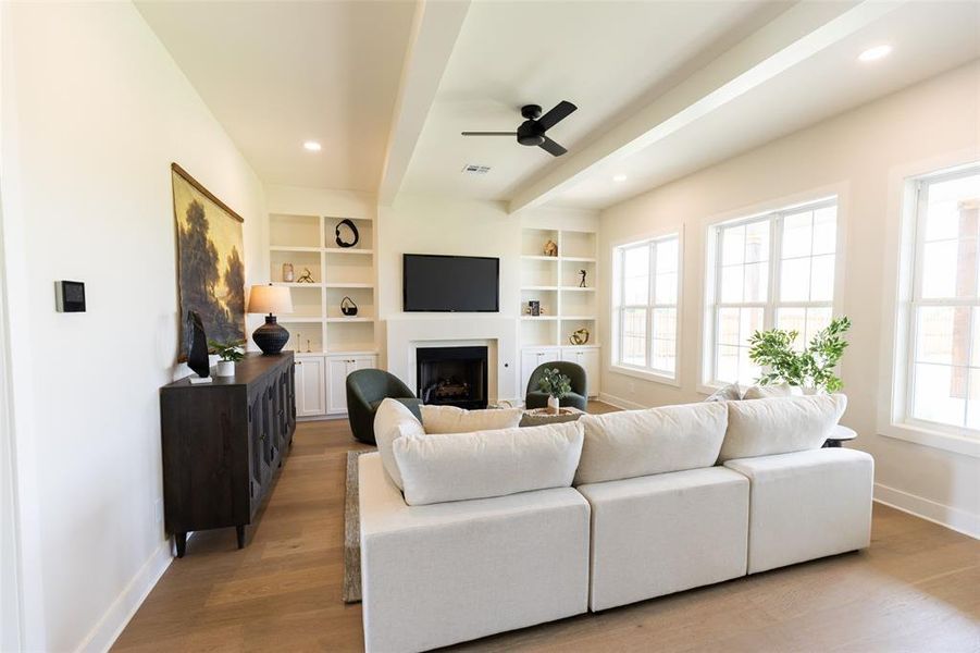 Living area featuring wood-finish flooring, recessed lighting, and a black ceiling fan