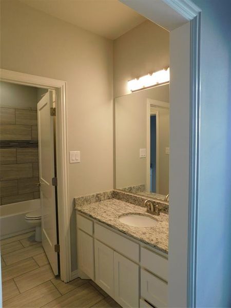 Full bathroom featuring shower / bathing tub combination, vanity, and toilet