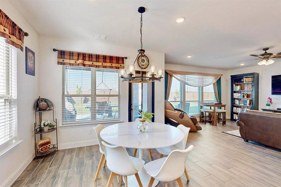 Dining space featuring wood finish floors, recessed lighting, and a chandelier